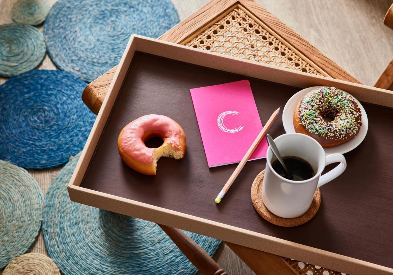 C Palmar - All Inclusive Belle Mare Exterior foto A tray with a cup of coffee and donuts